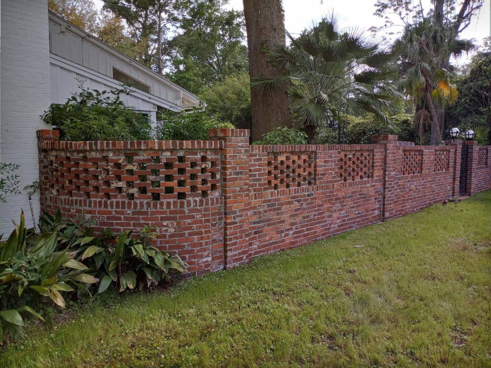 Brick house fence after being cleaned by Hydro-Kleen Pressure Washing team
