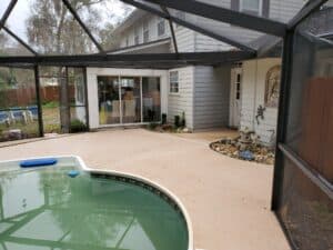 A professional pressure washing service cleaning a concrete driveway, removing dirt and grime with high-pressure water jets.