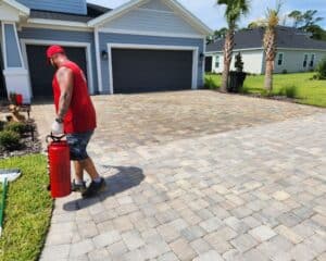 Hydro Kleen employee cleaning the driveway of a residential house