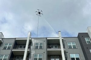 drone pressure washing Jacksonville FL - A drone capturing an aerial view of a residential property being pressure washed in