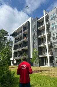 drone pressure washing Jacksonville FL - A drone capturing aerial footage of a residential property undergoing pressure washi